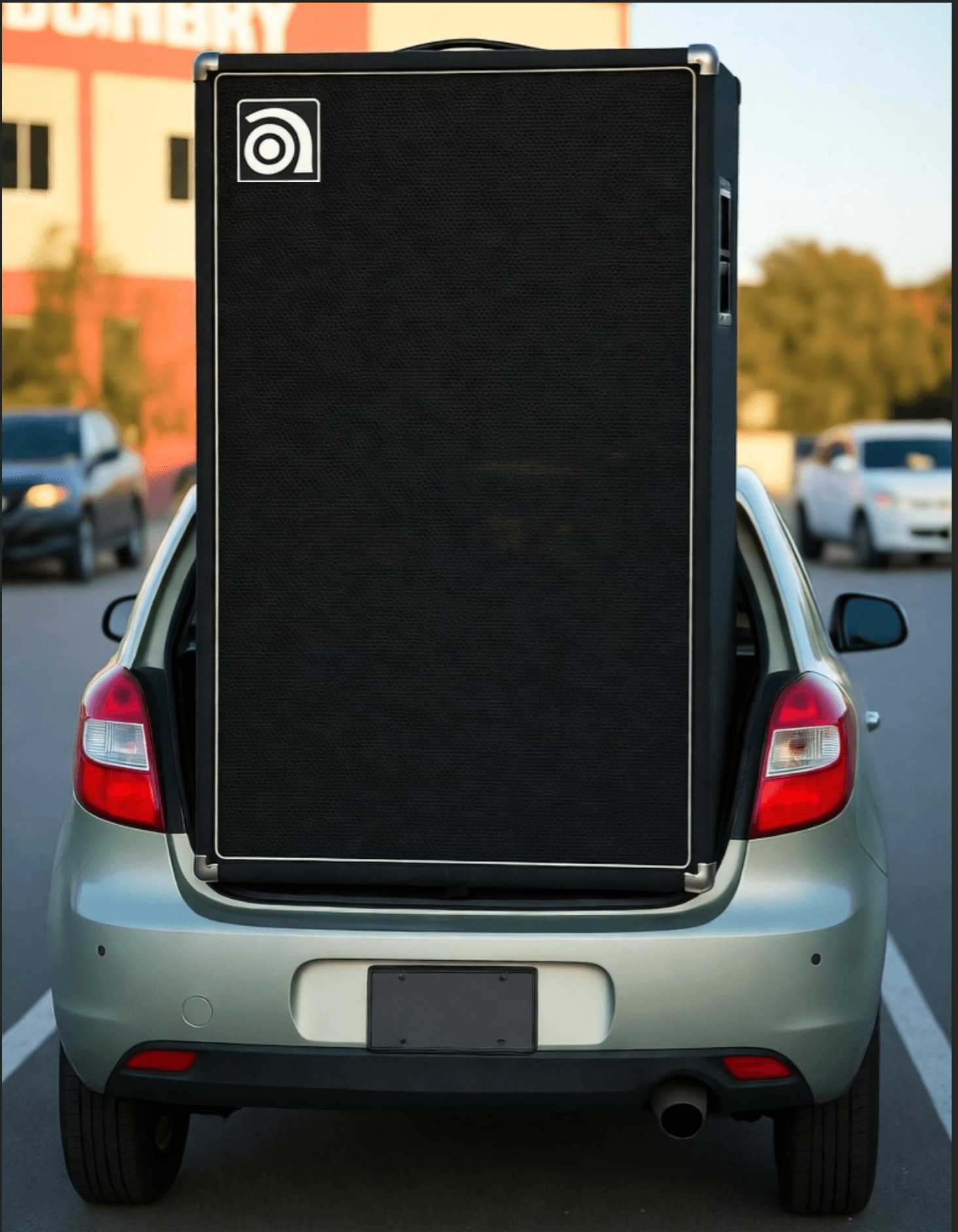 Giant Ampeg bass cabinet in trunk of tiny car