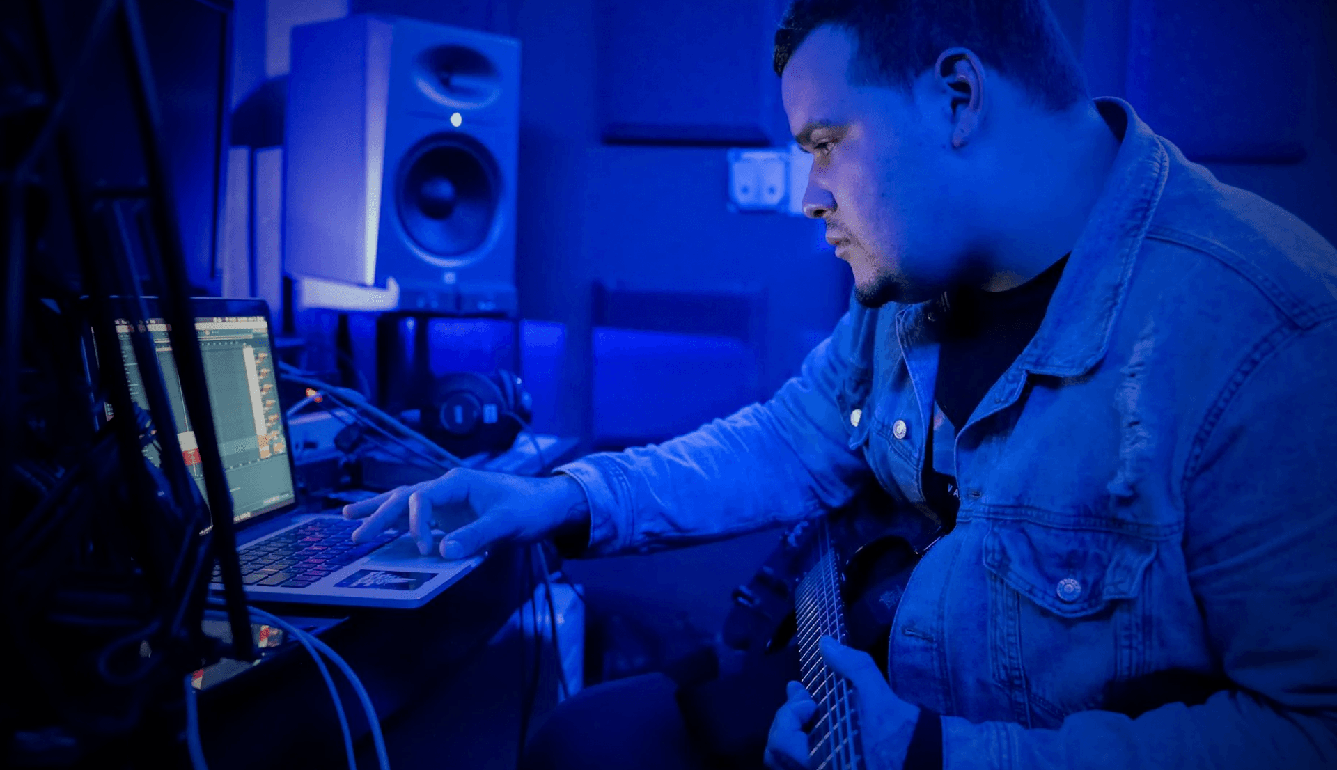 person recording guitar in home studio