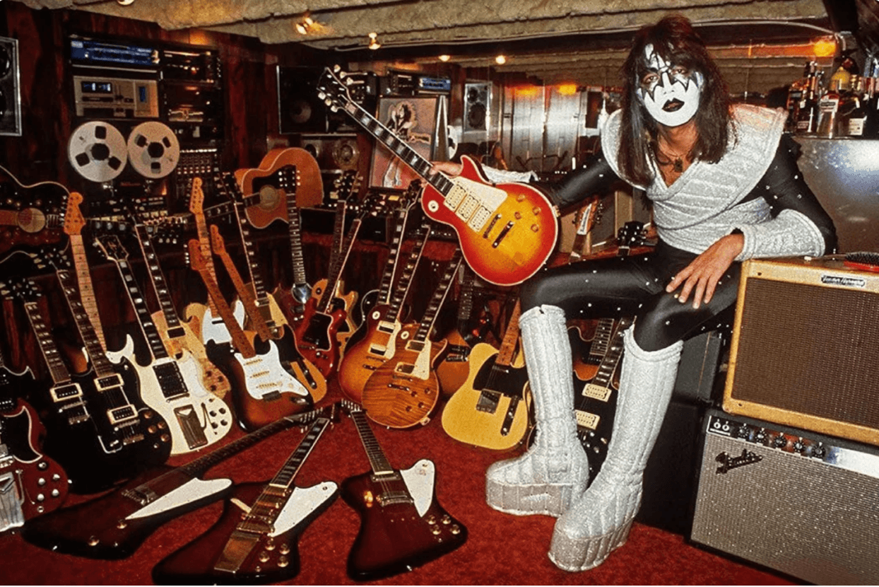 Ace Frehley in KISS makeup in a studio full of guitars and amps