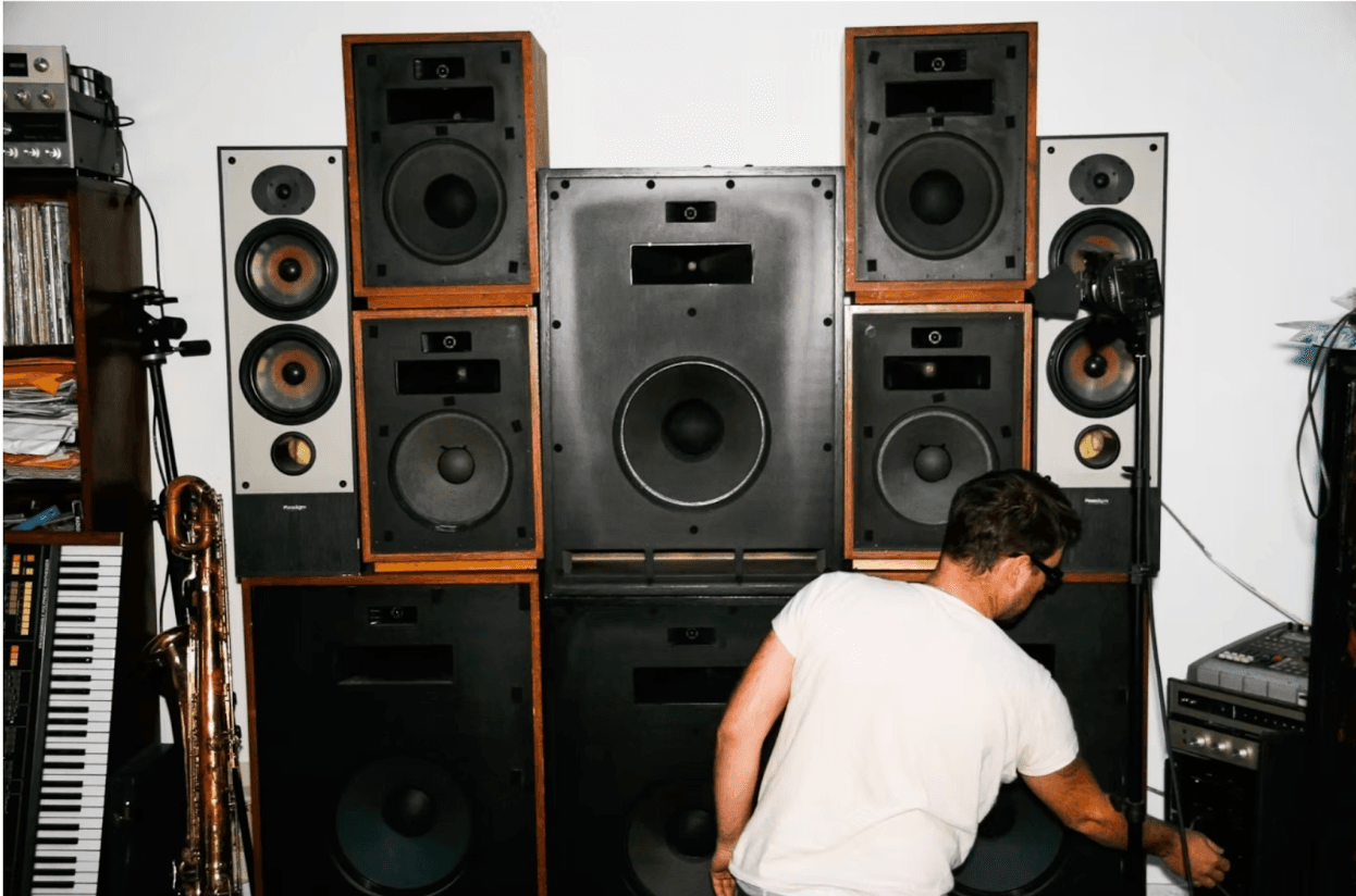 Dave Sitek in front of speakers