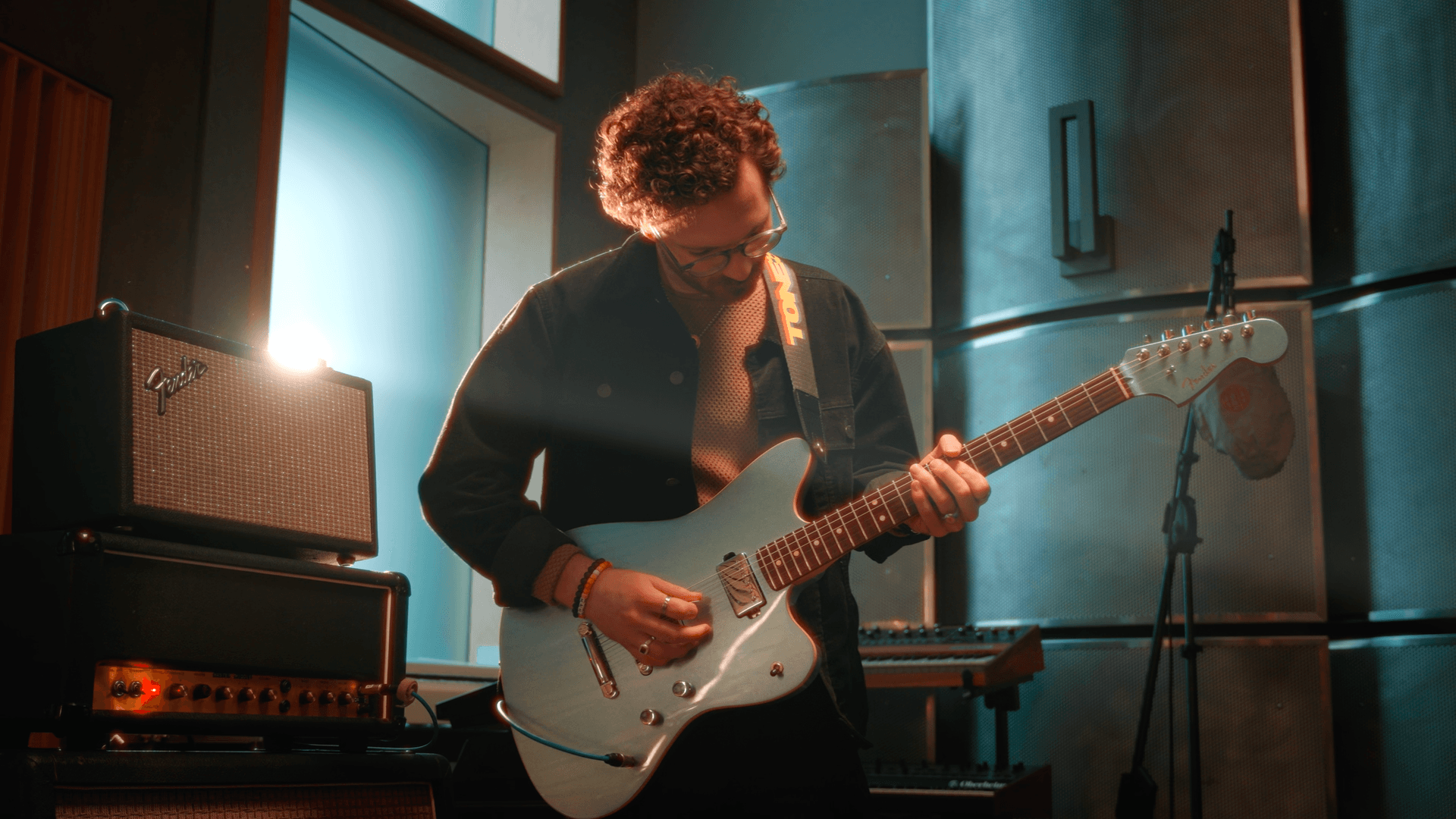 blue guitar in a recording studio